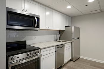 Renovated kitchen with granite countertops and stainless steel appliances  at Lenox Club, Virginia, 22202