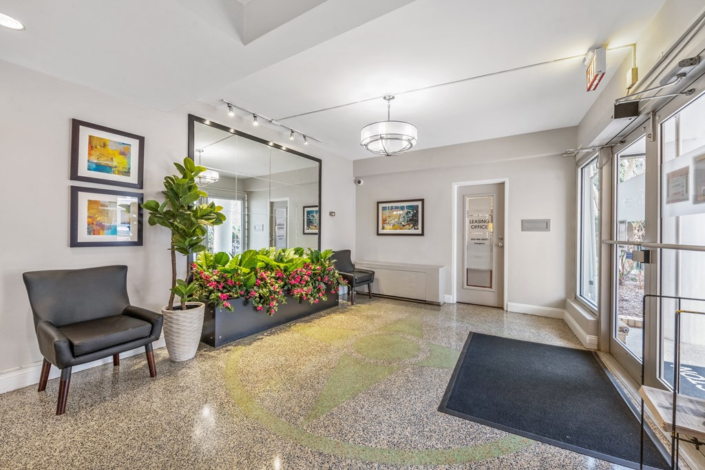 a lobby with a large mirror and a black chair