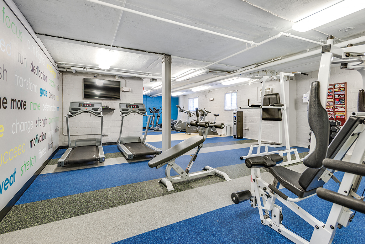Fitness center with treadmills, machines and free weights at Mason Hall in Alexandria, VA 22314