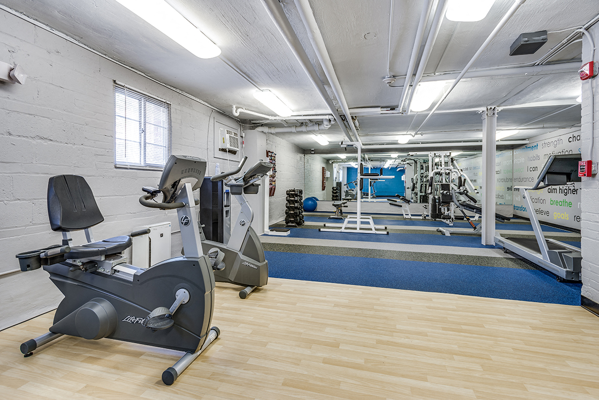 Fitness center with treadmills, machines and free weights at Mason Hall in Alexandria, VA 22314