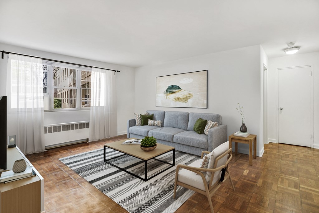 Living room with a gray couch and a coffee table at Mason Hall in Alexandria, VA 22314