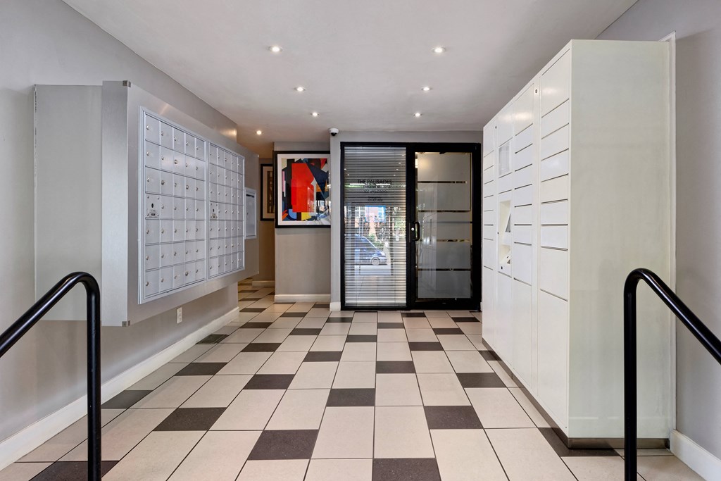 a locker room with white cabinets and a black door