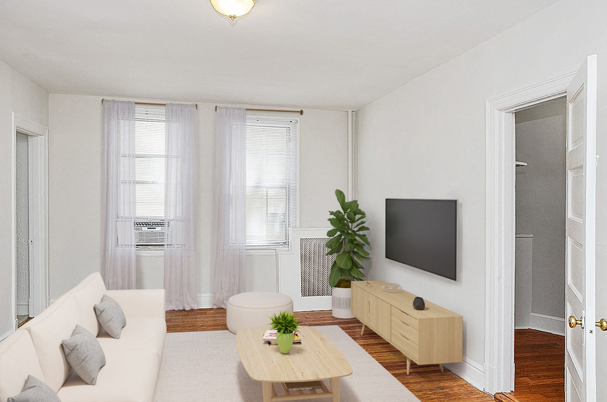 a living room with a white couch and a tv