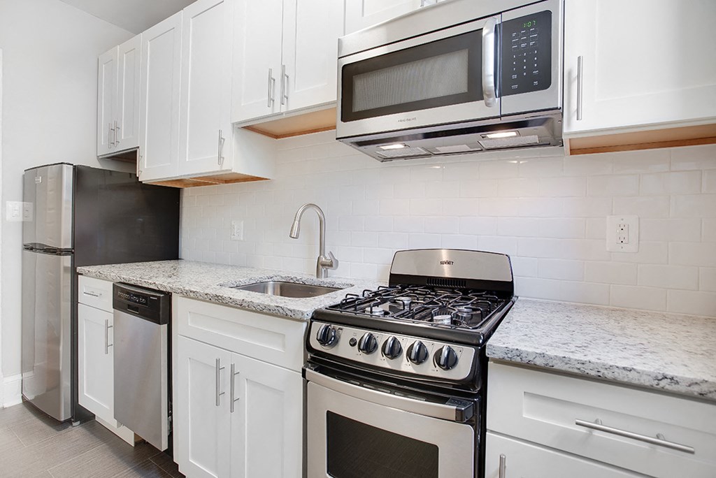 Renovated kitchen with granite countertops and stainless steel appliances at President Madison, Washington