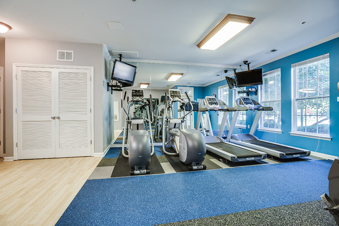 Fitness center with treadmills, machines and free weights at The Residences at King Farm Apartments, Maryland, 20850