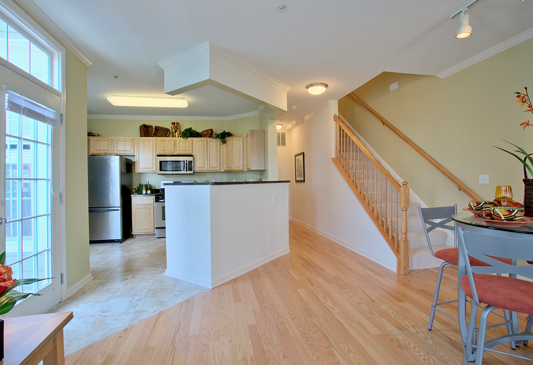 Townhome kitchen and dining area (staged) at The Residences at King Farm Apartments, Rockville, Maryland