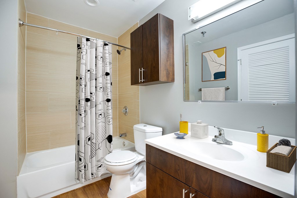 a bathroom with a shower toilet and sink and a mirror at Residences at Rio, Gaithersburg, MD, 20878