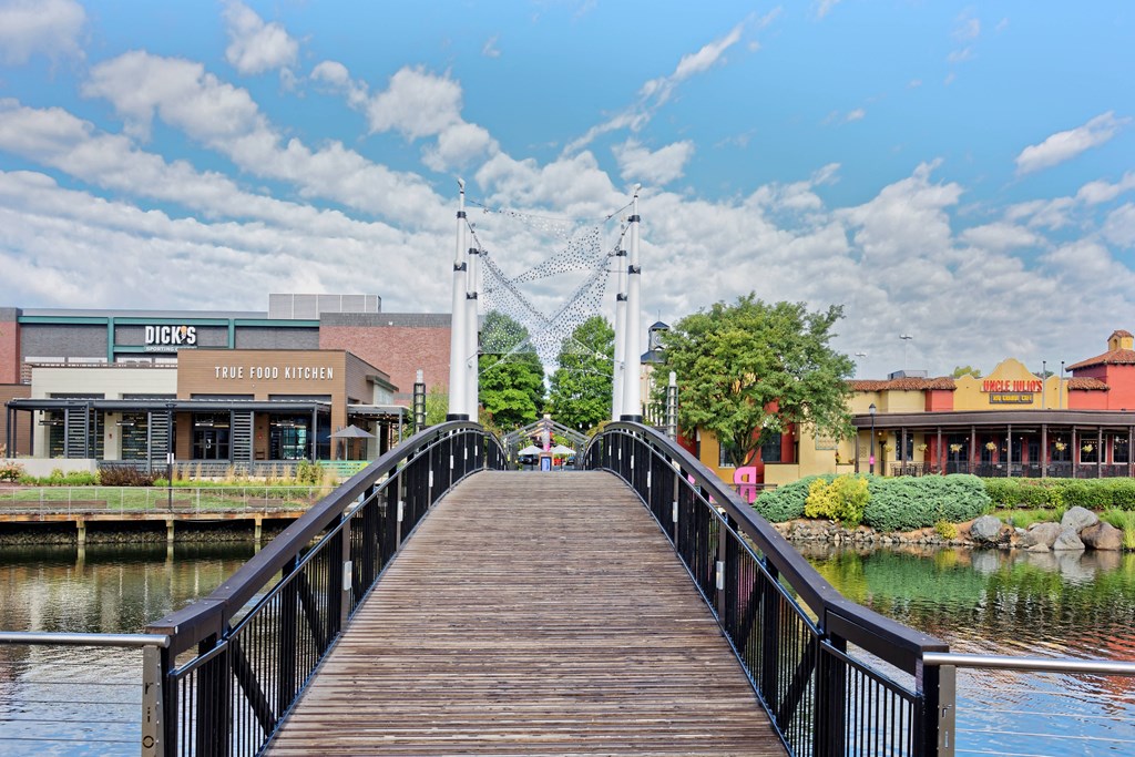 a bridge over a body of water with buildings on either side at Residences at Rio, Maryland