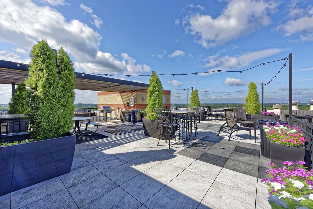 an outdoor patio with tables and chairs and awning