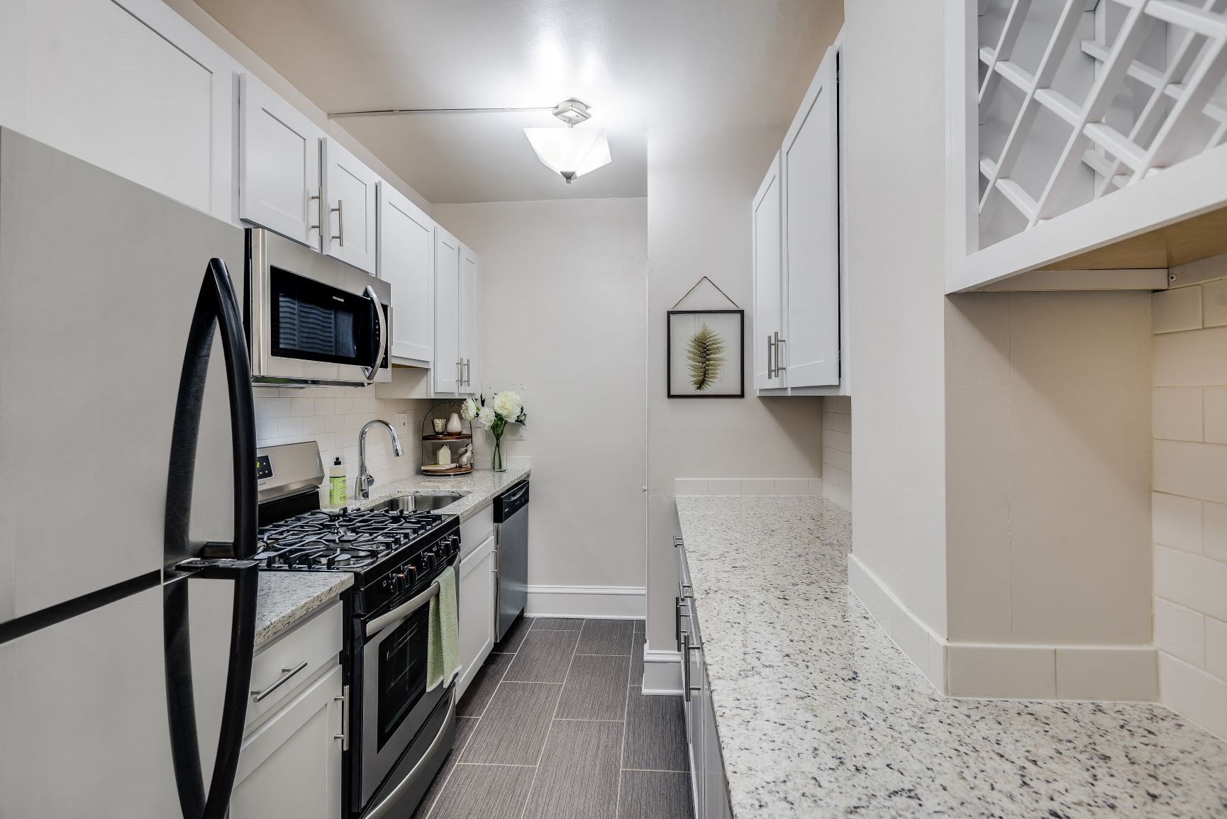 a kitchen with black appliances and white cabinets