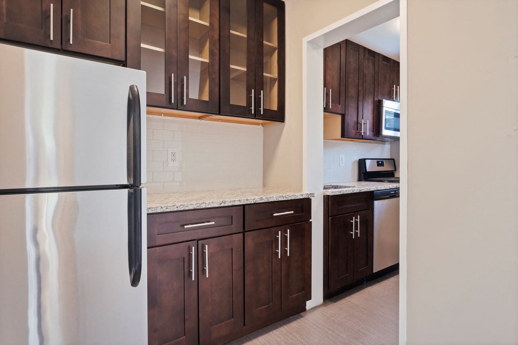 Renovated kitchen with granite countertops and stainless steel appliances at 2100 Connecticut, Washington, DC