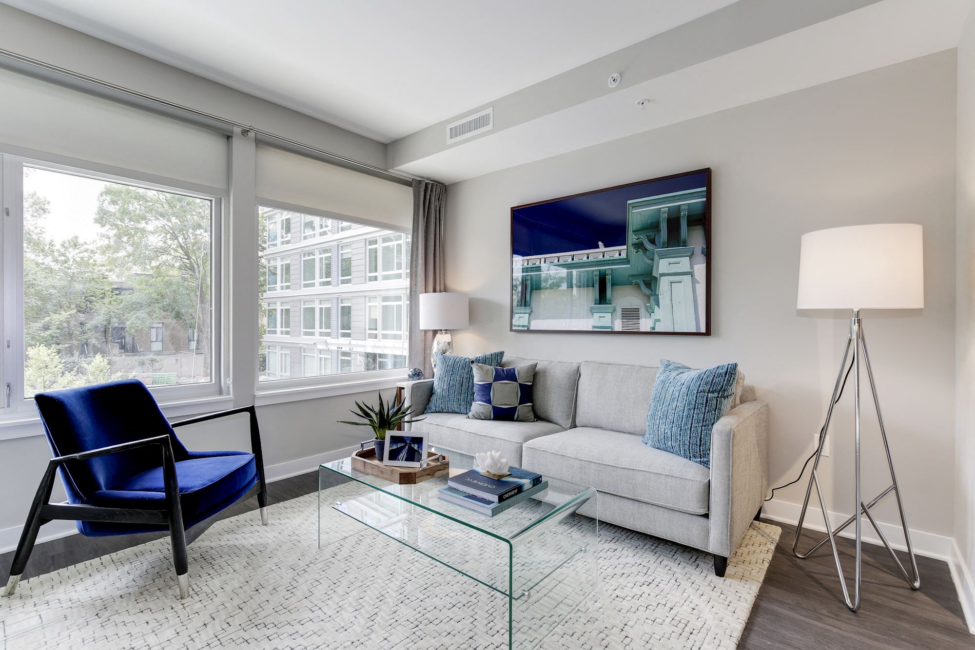 a living room with a couch and a glass coffee table