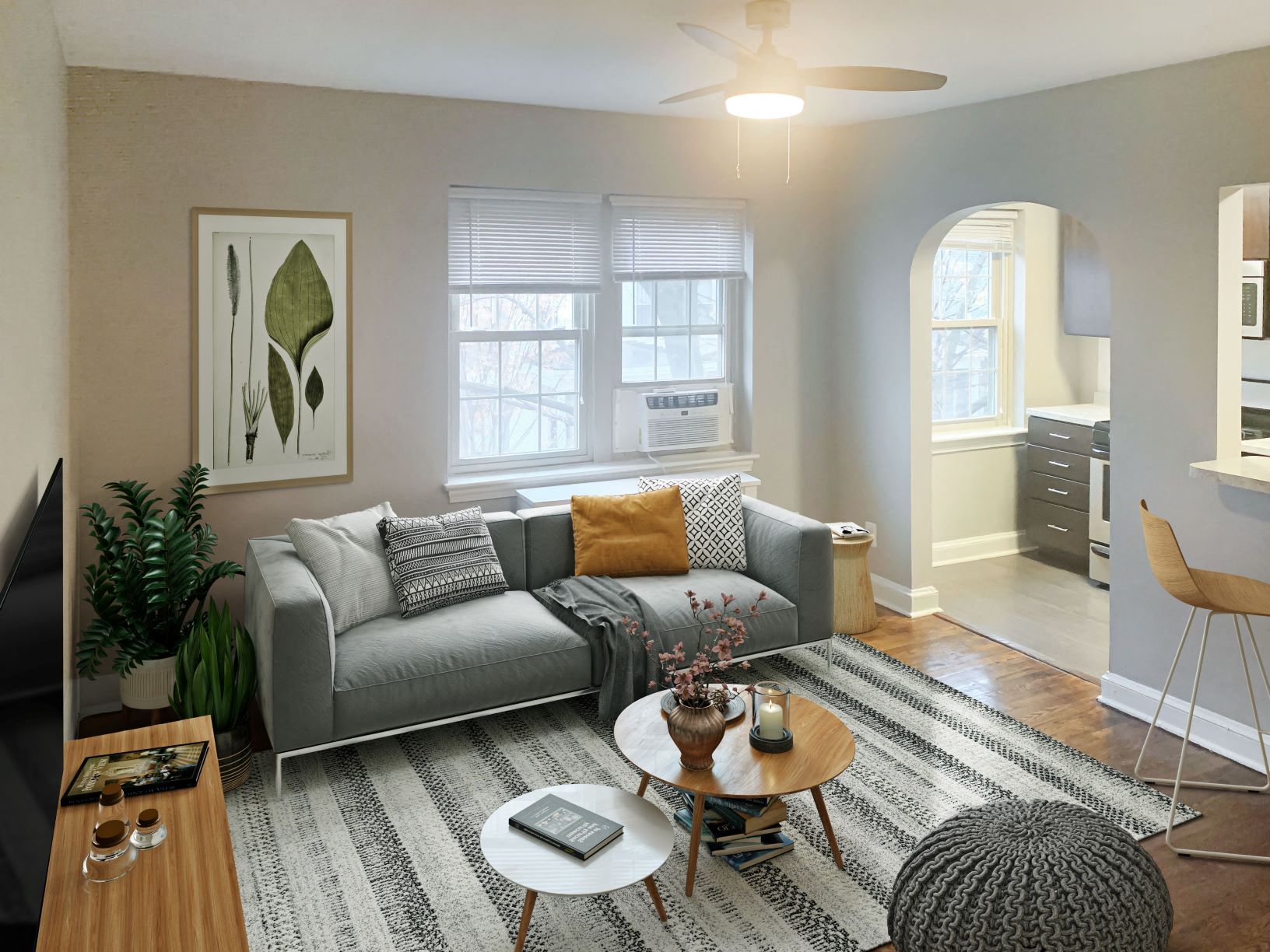 a living room with a gray couch and a rug