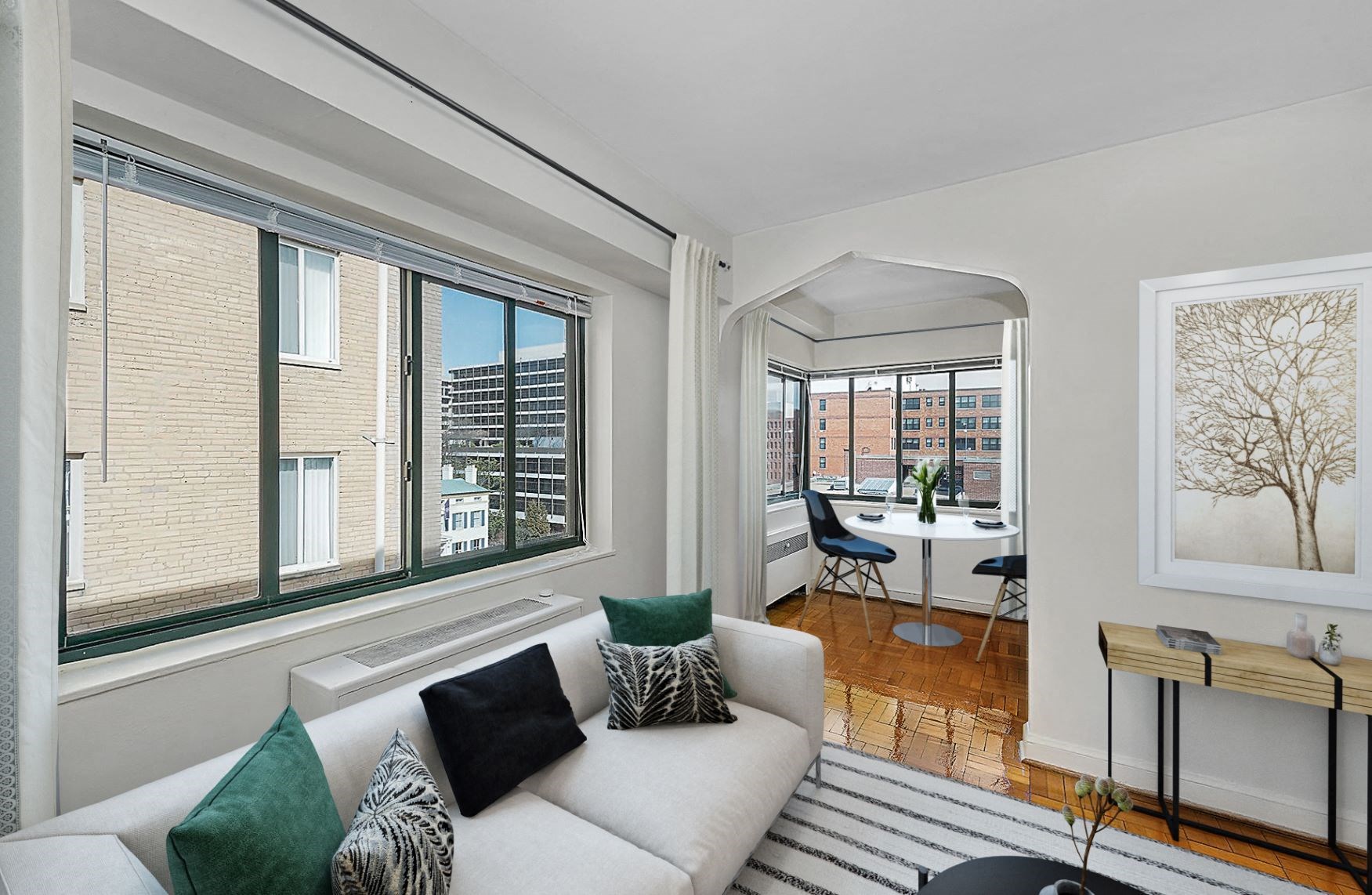 a living room with large windows and a white couch