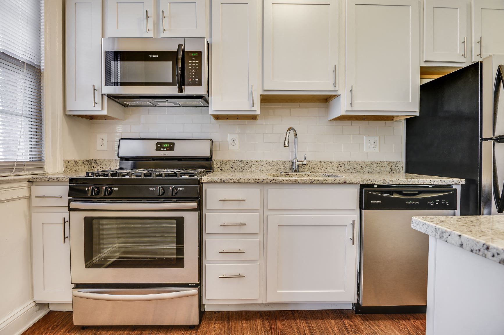 Renovated kitchen with stainless steel appliances and granite countertops  at Kew Gardens, Washington, DC