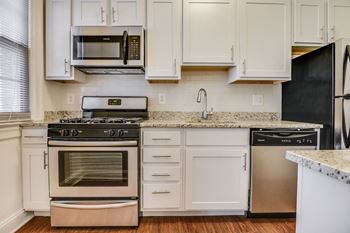 Renovated kitchen with stainless steel appliances and granite countertops  at Kew Gardens, Washington, 20007