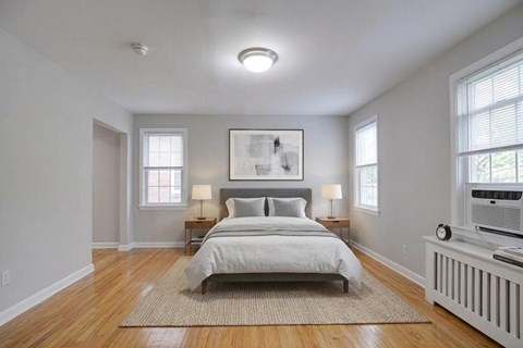 A bedroom with a large bed and a window.