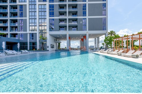 A large swimming pool in front of a modern building.