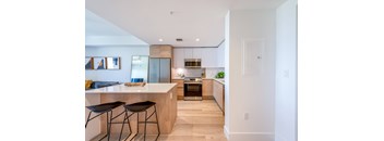 A modern kitchen with a bar stool and a countertop.