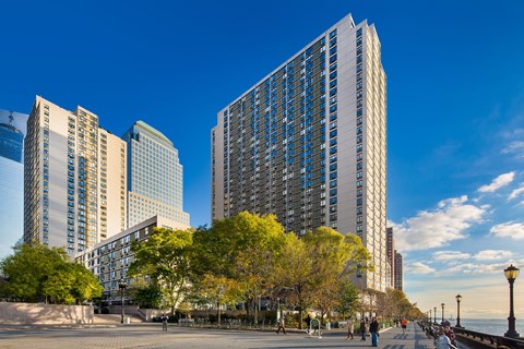 A cityscape with tall buildings and a clear blue sky.