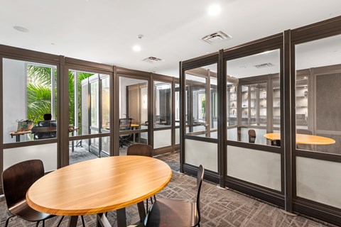 A conference room with a table and chairs.