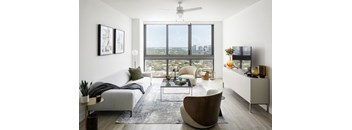 A modern living room with a large window overlooking the city.