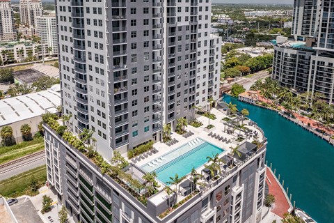A tall building with a pool in the middle of it.