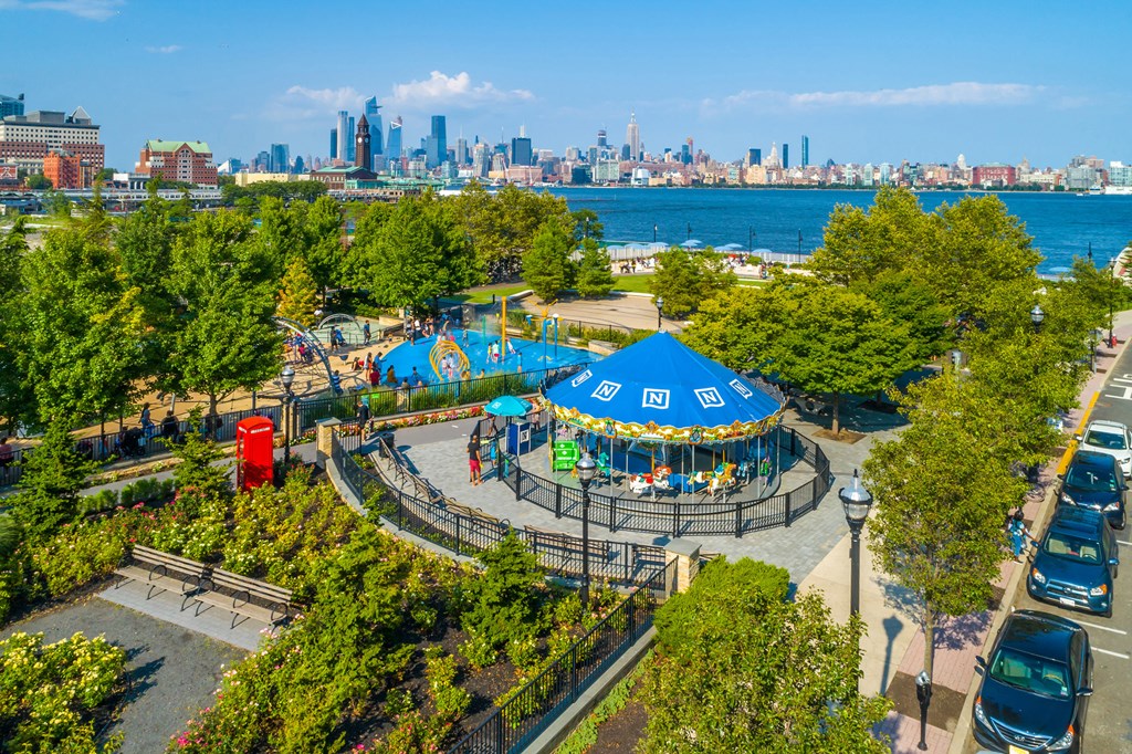 Newport Green park with carousel and views of manhattan
