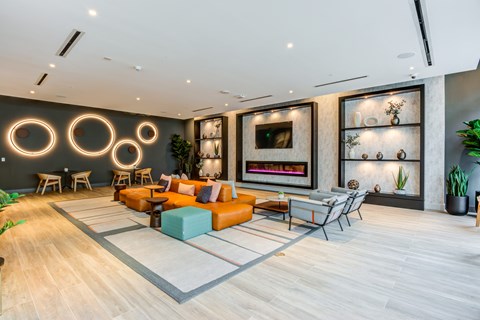 A modern living room with a fireplace and a large painting on the wall.