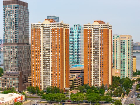 A cityscape with tall buildings and a clear sky.