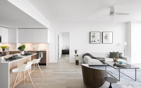 A modern kitchen with a dining table and chairs.