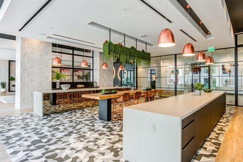 A modern kitchen with a long island and a dining table with chairs.