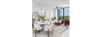 A modern living room with a dining table set for two.