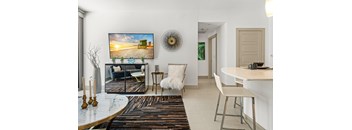A living room with a television, a chair, and a table.