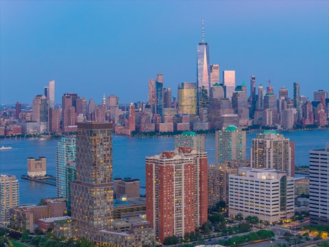 A city skyline with a large body of water in the foreground.