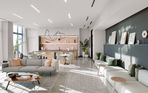 A modern living room with a grey sofa, a coffee table, and a dining table set up.