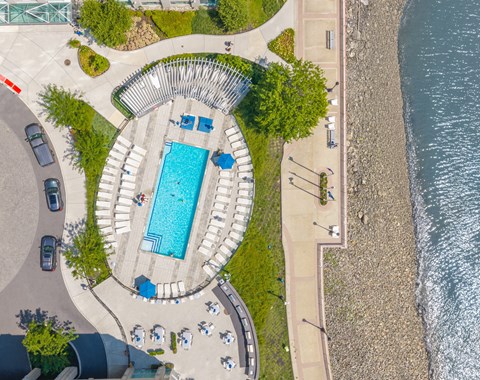 An aerial view of a pool surrounded by a stone wall.