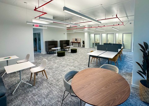 A modern office space with a wooden table in the foreground.