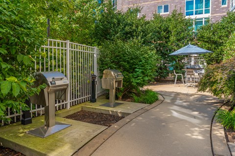 A metal gate with a small umbrella next to it.