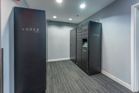 A room with two LUXER vending machines.