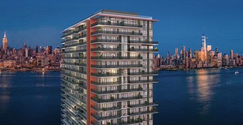 an aerial view of a tall building overlooking the water and the city