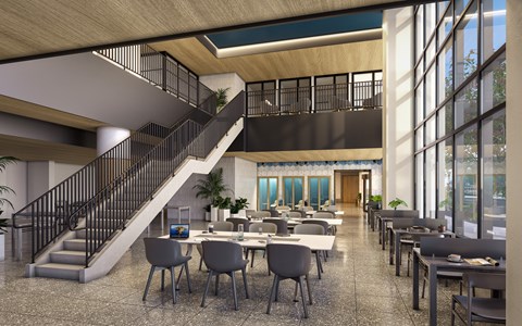 a rendering of a lobby with tables and chairs and a staircase
