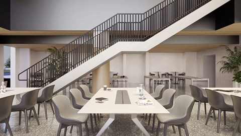 a dining room with tables and chairs and a staircase