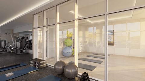 a gym with exercise equipment and glass walls