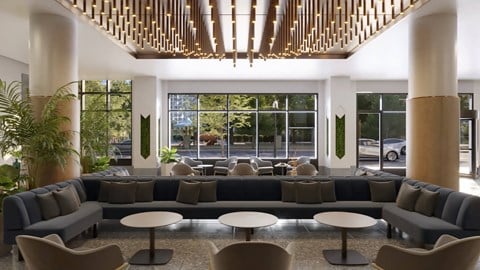 a lobby with couches and tables and a large window