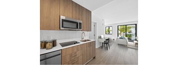 A modern kitchen with wooden cabinets and a stainless steel dishwasher.