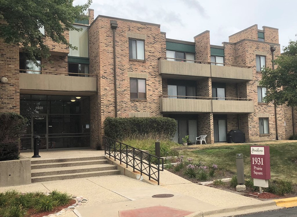 an apartment building with a staircase in front of it