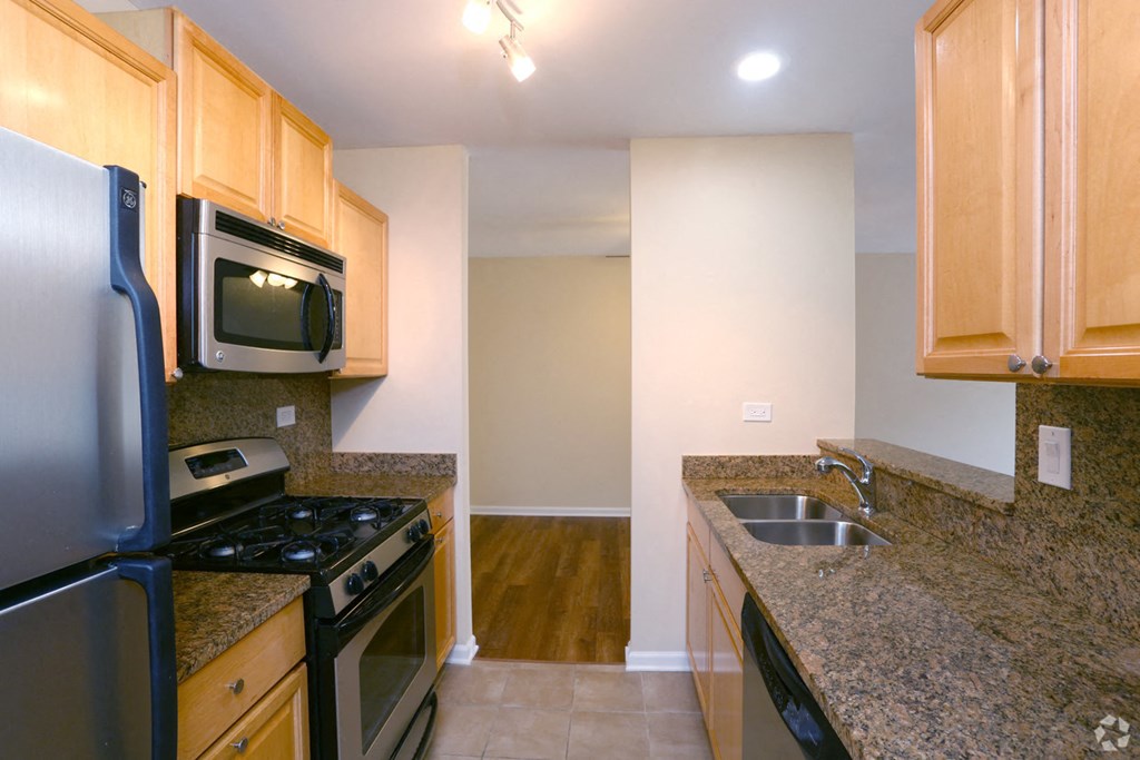 a kitchen with granite counter tops and stainless steel appliances