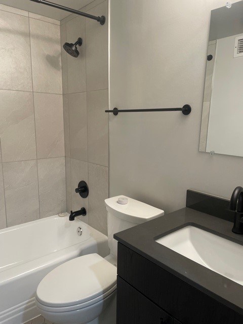 A white toilet is next to a sink in a bathroom. at 2400 Pennsylvania Avenue Apartments, Washington, DC,20037