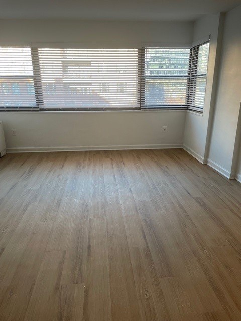 A room with wooden flooring and a window with blinds. at 2400 Pennsylvania Avenue Apartments, Washington, DC,20037
